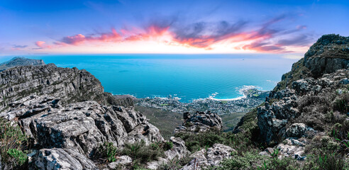 Table mountain from the top, looking out towards the Southern coastline with vibrant sunset sky - Great outdoors adventure travel destination, Cape Town, South Africa