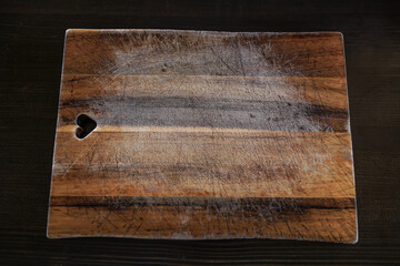 Rustic wooden cutting board on table