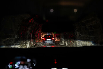 Cars in tunnel on mountain road