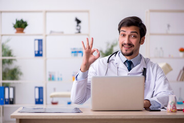 Young male doctor in telemedicine concept