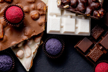 Chocolate bar, crushed pieces of dark chocolate and nuts. Praline Chocolate sweets