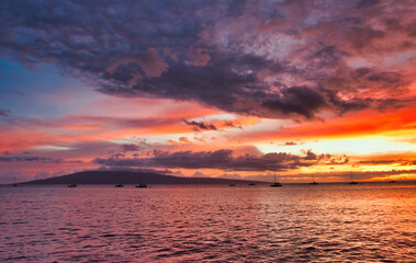Naklejka premium Firey sunset sky with Lanai seen from Maui.