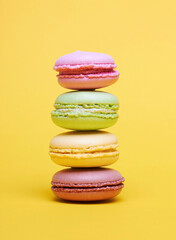 Colored macarons on a yellow