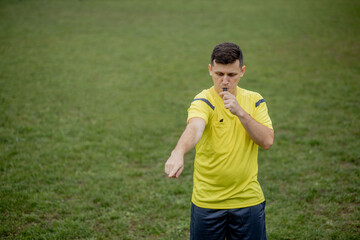 Referee showing on penalty while gaming. Concept of sport, rules violation, controversial issues,...