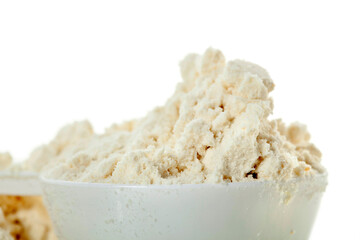 Spoon of protein powder isolated on a white background.