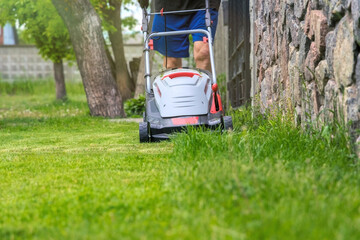  Lawn mower in front of a mown green lawn