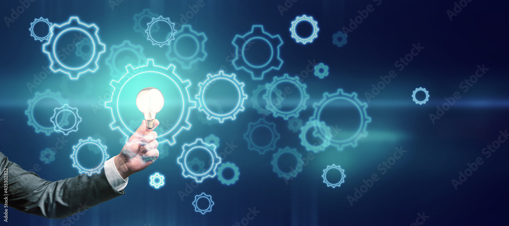 Poster Idea and start up concept with glowing digital gears and light bulb in businessman hand on abstract background.