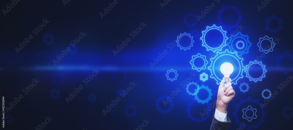 Poster Start up and business idea concept with abstract dark blue backdrop with space for your text and man hand with light bulb surrounded by digital gears. Mockup