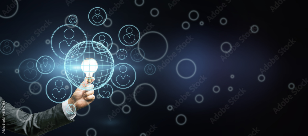 Poster Startup investment concept with man hand with glowing light bulb and abstract dark background with digital human figures in circles icons. Mock up