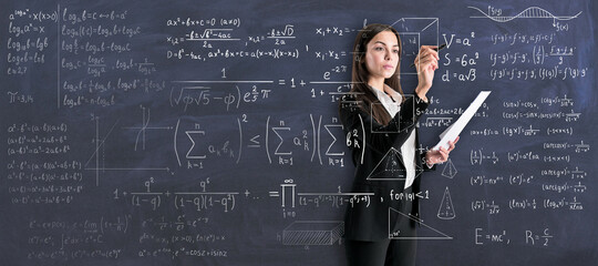 Studying process with young woman in black suit writing on transparent wall math calculations. - obrazy, fototapety, plakaty
