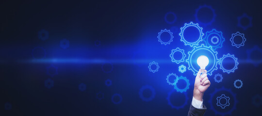 Start up and business idea concept with abstract dark blue backdrop with space for your text and man hand with light bulb surrounded by digital gears. Mockup