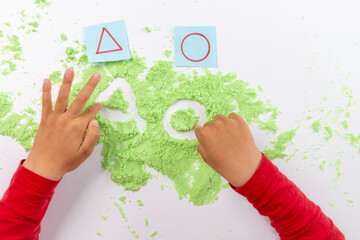 sand tray writing, shape practice for kids, preschool writing activity, kids hands