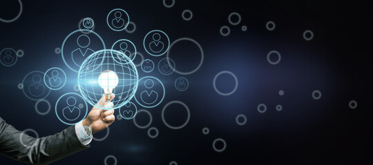 Startup investment concept with man hand with glowing light bulb and abstract dark background with digital human figures in circles icons. Mock up
