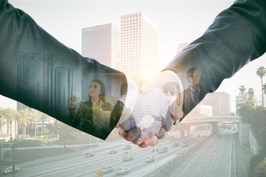 Businessmen shaking hands closeup with city view in the background. Partnership and cooperation concept