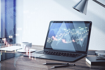 Online investing concept with digital financial chart graphs and home work place with stock market indicators on laptop screen. Double exposure.