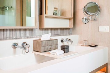 Fototapeta na wymiar Modern cream marble sink in a luxurious bathroom