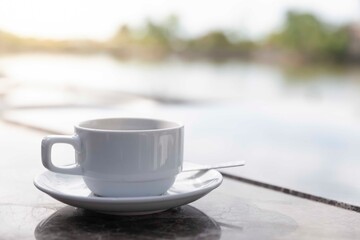 Coffee cups placed at the breakfast table by the river.