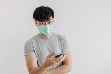 Asian man wear mask and using phone application isolated on white background.