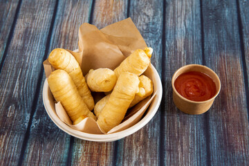 home delivery bowl with tequeños and dipping sauce