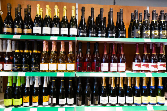 BARCELONA, SPAIN - NOVEMBER 07, 2019: Racks with cava in supermarket - traditional spanish rose and white sparkling wine