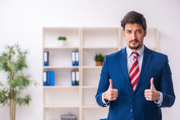 Young male employee unhappy with excessive work in the office