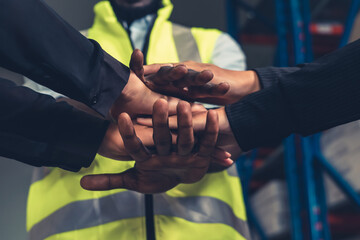 Factory workers stacking hands together in warehouse or storehouse . Logistics , supply chain and warehouse business concept .