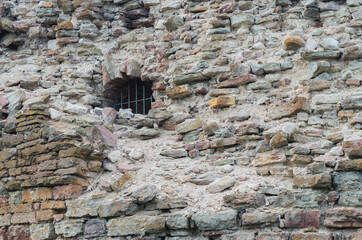 Ruins of an old fortress. Old destroyed brickwork with grating.