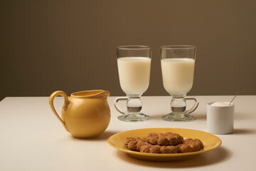 Healthy fresh milk and cookies, on white table and dark background.