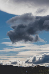 beautiful sky with clouds rolling over the mountains in Tasmania, Australia