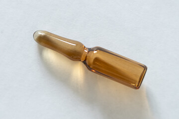 Medical ampoule lies on the table.