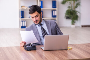 Young handsome businessman employee working in the office