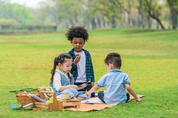 multi ethnic and diverse group of children playing together in park