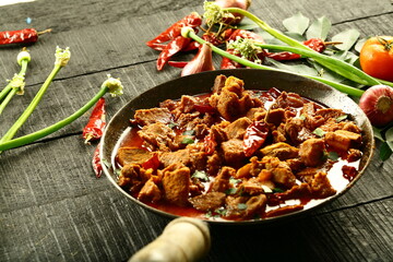 Homemade mutton korma curry cooked in iron skillet- traditional Indian recipes.