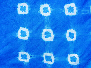 Indigo blue fabric tie dye pattern background. Indigo-Dyed fabric texture with abstract ethnic graphic motif pattern.