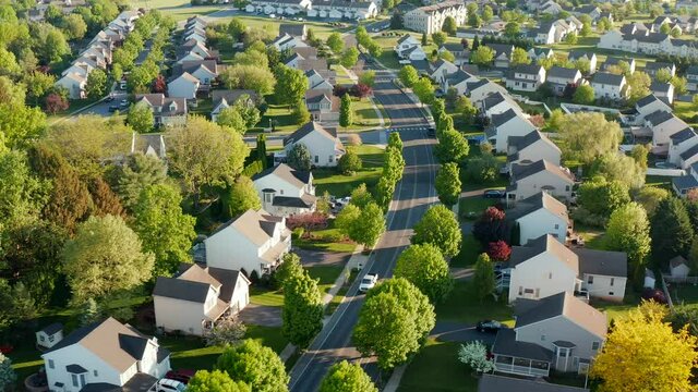 Truck drives through suburban residential housing development. Aerial of modern home community in United States of America, USA. American suburbia. Population growth theme.