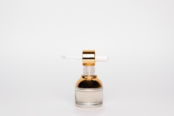 Transparent golden bottle with pipette and hylauronic acid. Top horizontal view copyspace
