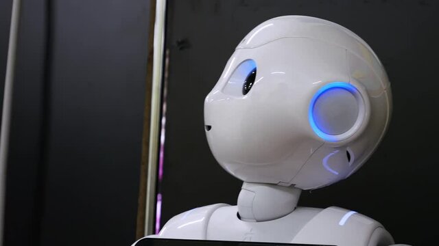 The friendly robot communicates with people. Humanoid cyborg demonstrates advanced communication skills