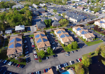 aerial view of apartment buildings with solar panel installed on roof 