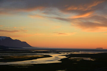 Fototapeta premium Beautiful midnight sunset over the marshes, cliffs, and bay near saudarkrokur, in northern Iceland 