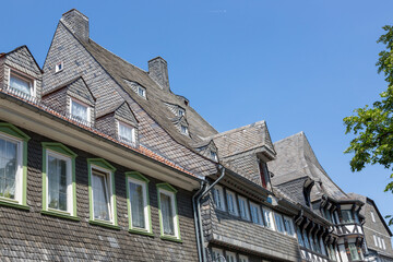 Fototapeta na wymiar Detail of a house made of natural slate tiles in Goslar in Germany