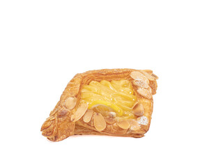 Danish pastry, a close up of homemade delicious sweet cream danish with sliced lemon and almond isolated on white background.