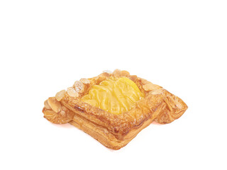 Danish pastry, a close up of homemade delicious sweet cream danish with sliced lemon and almond isolated on white background.
