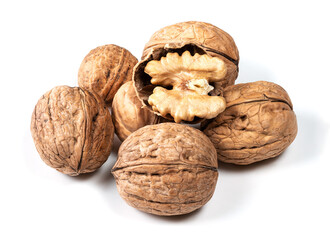 several whole and shelled walnuts on white