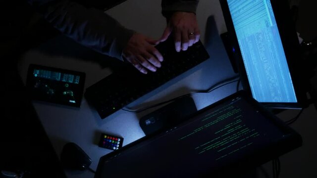 Overhead shot of computer hacker typing code