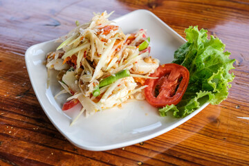 Papaya salad on the wooden table, Thai food.
