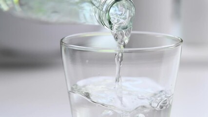 Pouring water from bottle - slow motion - Powered by Adobe