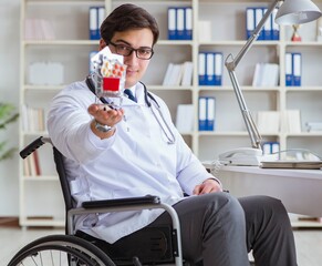 Disabled doctor on wheelchair working in hospital