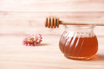 close up of fresh honey with spoon on table 
