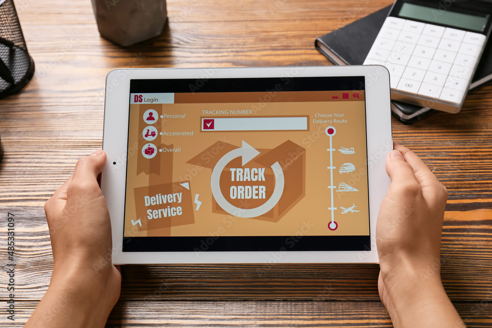 Poster woman holding tablet computer with open page of delivery service application on table