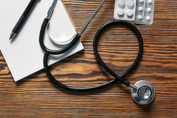 Composition with modern stethoscope on wooden background